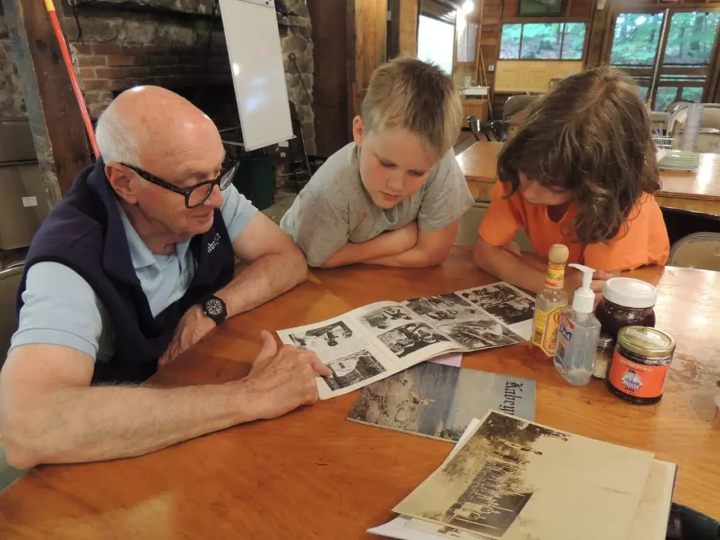 Past camper sharing stories with young campers Past camper sharing stories with young campers