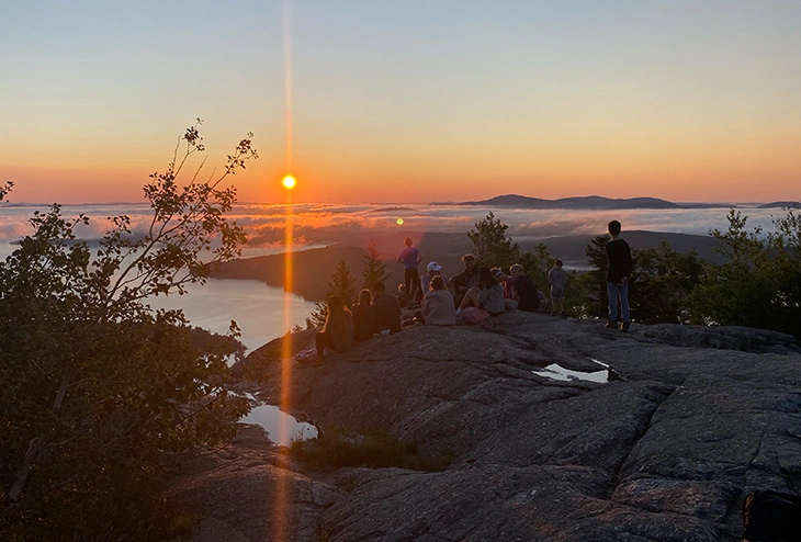 Boys watching sunrise on Lake Winnipesaukee Boys watching sunrise on Lake Winnipesaukee